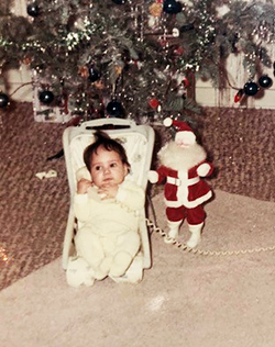The author as a baby in front of a Christmas tree